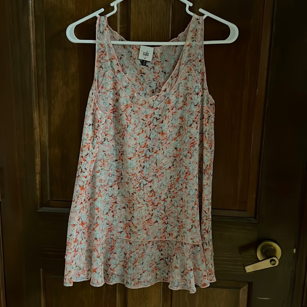 Flowy top with lots of detail.  Flowers and very feminine.
